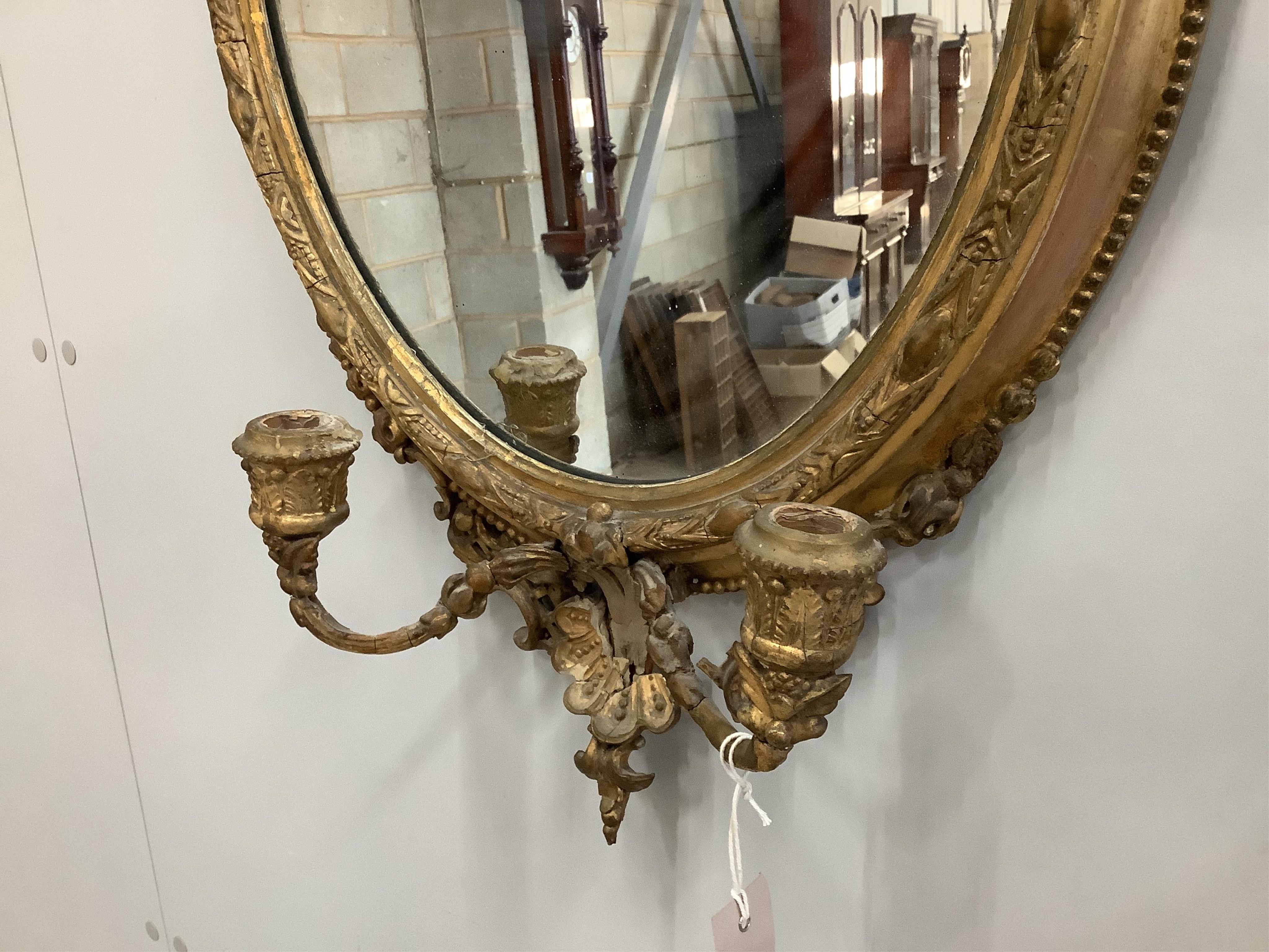 A Victorian giltwood and composition girandole wall mirror, width 43cm, height 73cm. Condition - poor to fair